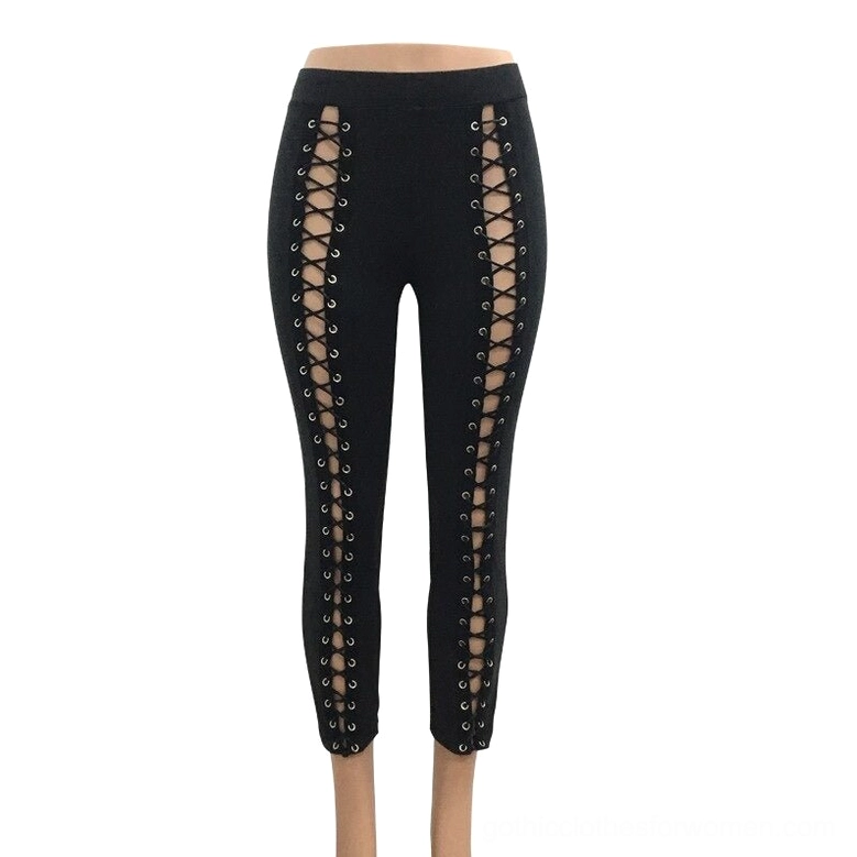 Black gothic lace-up leggings flat lay, showing high waist construction and dual side hollow cutout design