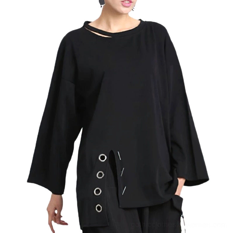 Black gothic casual long sleeve ladies top featuring neck cutout and asymmetric hem with eyelet trim details, front medium shot on model