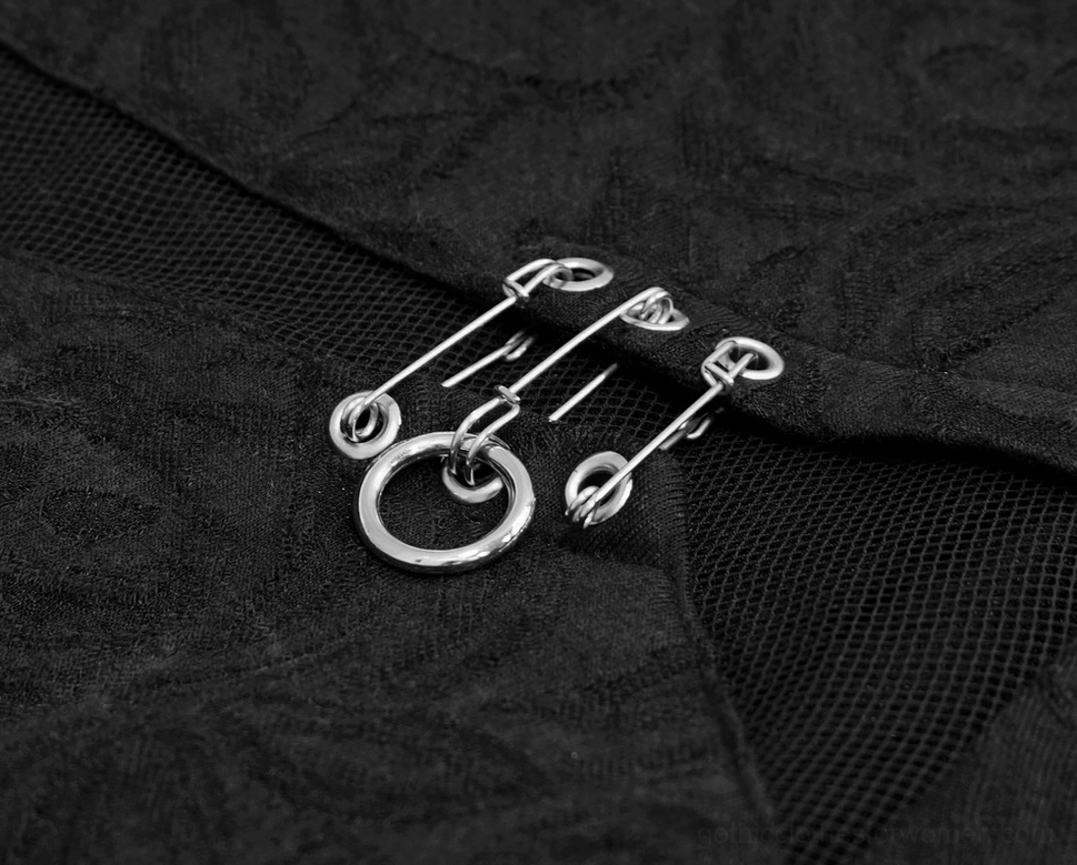 Black gothic long sleeve top flat lay showing mesh panel, safety pins, and overall construction quality