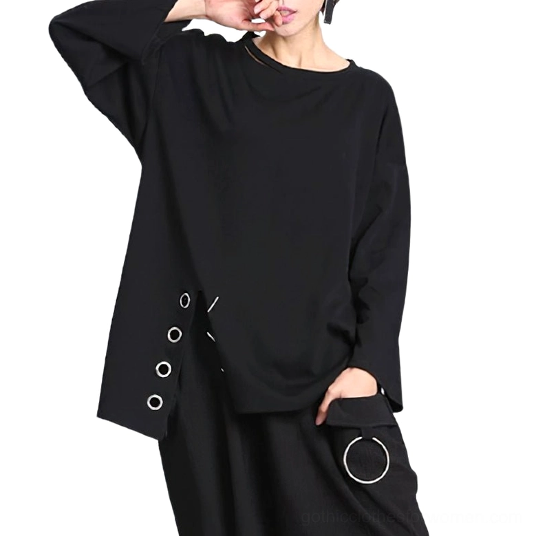 Black asymmetric gothic long sleeve pullover top with metal eyelets, worn by female model, three-quarter front view showing neck cutout and wide drop sleeves