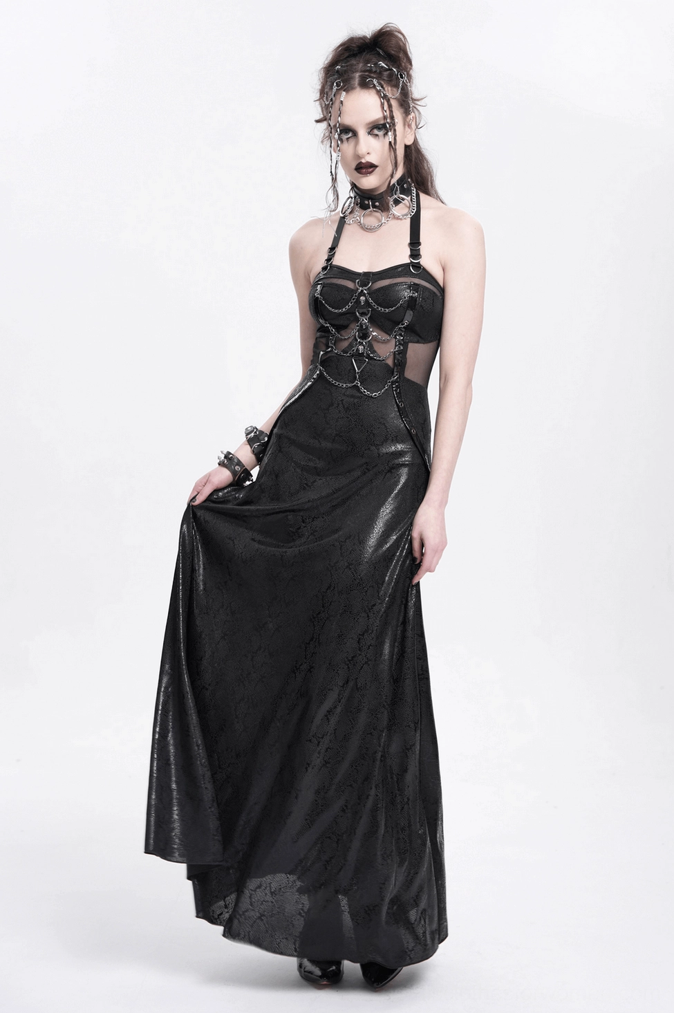 Black gothic maxi dress studio product shot with dramatic lighting highlighting chain embellishments and silhouette
