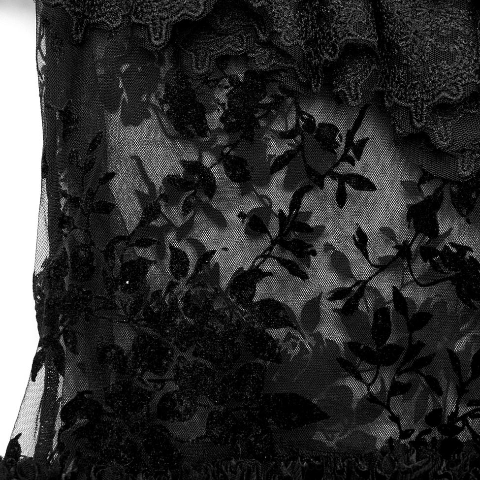 Detailed close-up of black gothic skirt fabric showing sheer mesh, velvet floral embroidery, and scalloped lace edge texture
