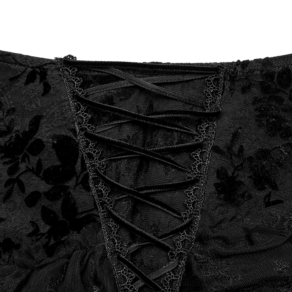 Close-up detail of black gothic maxi skirt's crisscross velvet lace-up fastener and delicate lace trim