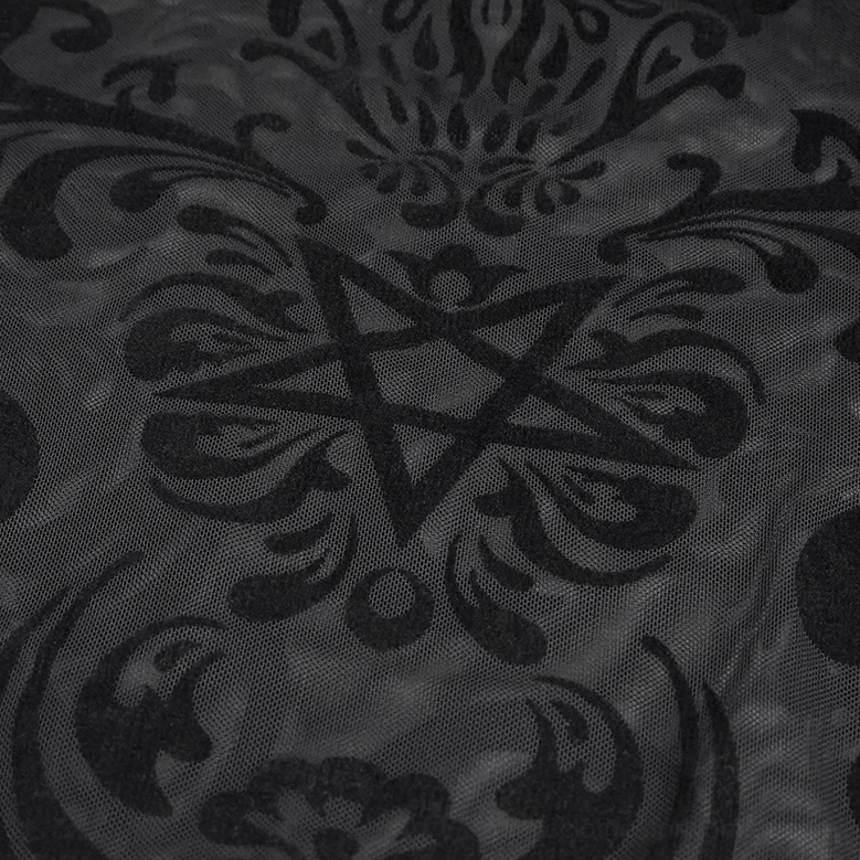 Flat lay close-up of black mesh fabric showing intricate pentagram and damask gothic print pattern
