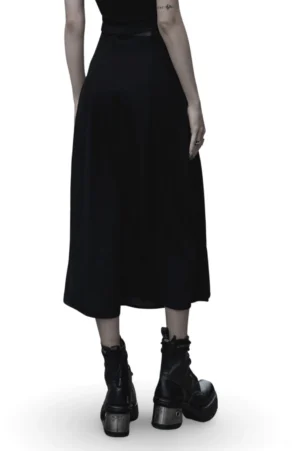 Black gothic midi skirt rear view showing smooth matte chiffon fabric and matching leather waist belt on model in white studio setting