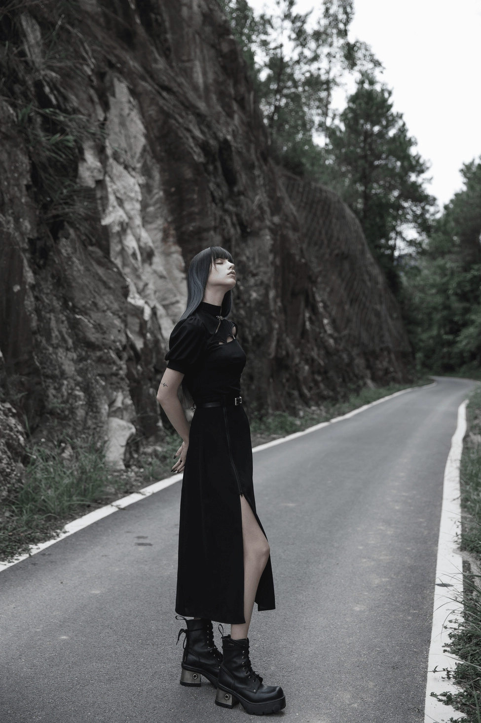 Black gothic A-line midi skirt front product display showing adjustable side zipper design with matching leather belt on white background