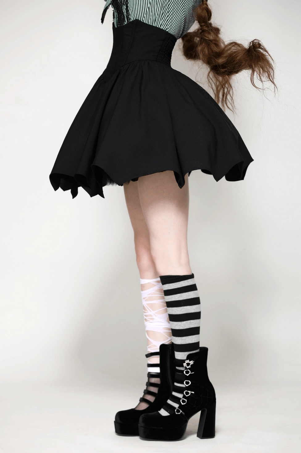 Gothic black mini skirt full product view showing A-line structure and bat wing hem