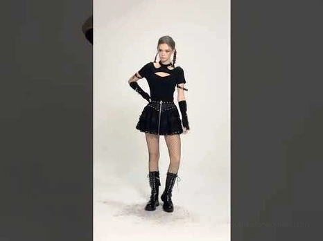 Full-body goth ensemble with black ruffled mini skirt, platform combat boots, and alternative accessories