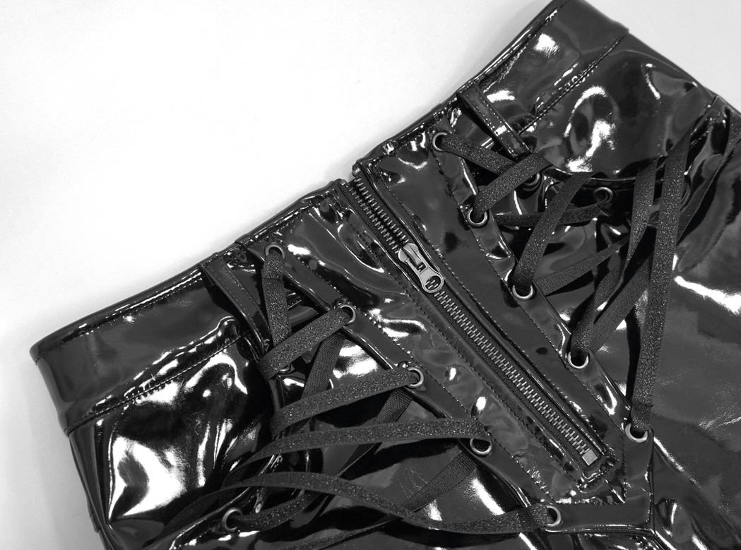 Full-length front view of black patent leather gothic mini skirt with front zipper and decorative lace-up detail