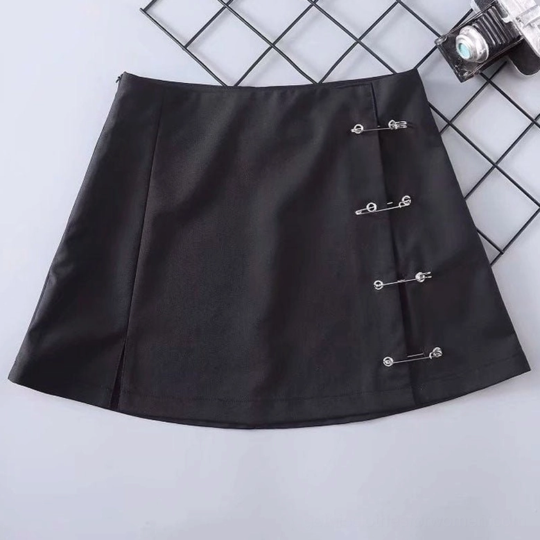 Black mini skirt with safety pins showing side slit and smooth fabric texture, flat lay angle view