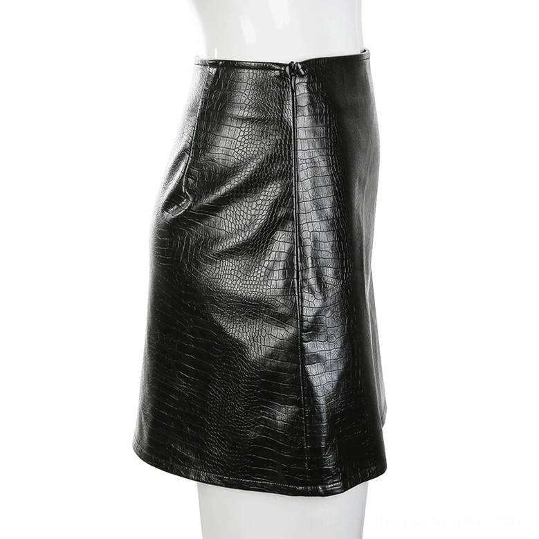 Black crocodile PU leather skirt side view on mannequin, fitted cut with side zipper and croc grain texture