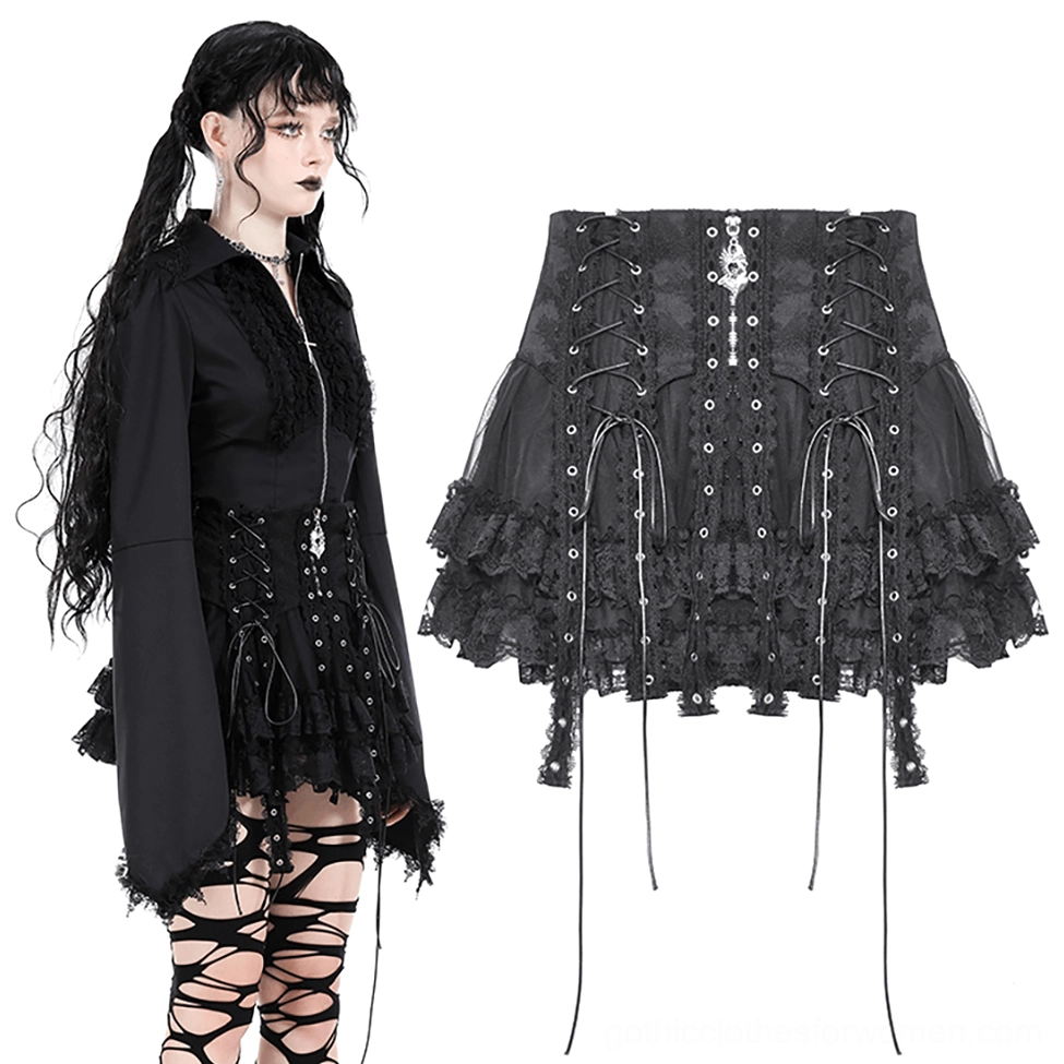 Goth model wearing black gothic lace mini skirt with cross necklace, three-quarter angle view showing skirt silhouette and details