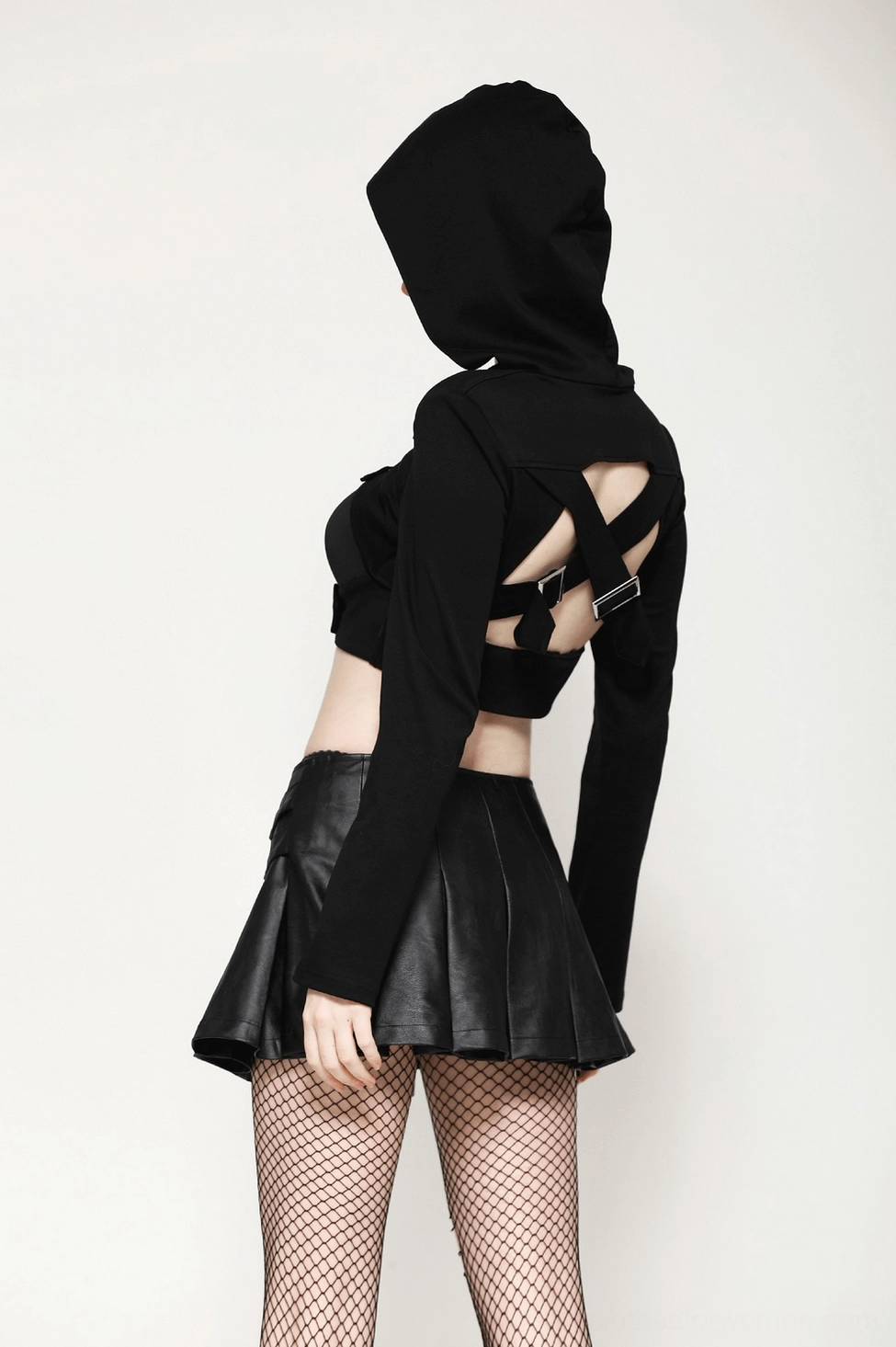 Black pleated faux leather gothic mini skirt styled with silver buckle accents, alternative fashion aesthetic