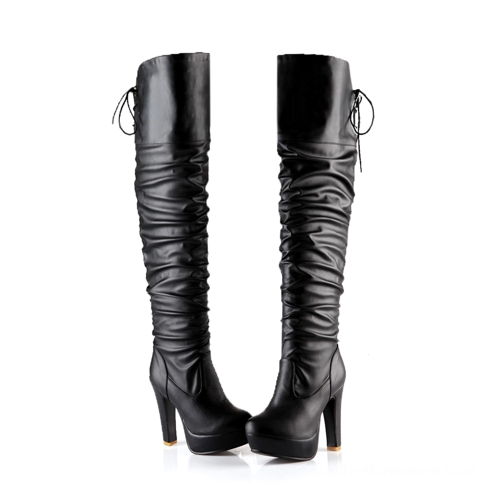 Pair of black gothic over-the-knee platform boots with ruched shaft and back lace-up detail, front view