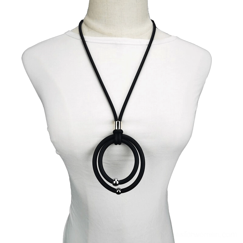 Black gothic rubber cord pendant necklace with dual round pendants and metal accents worn on white mannequin