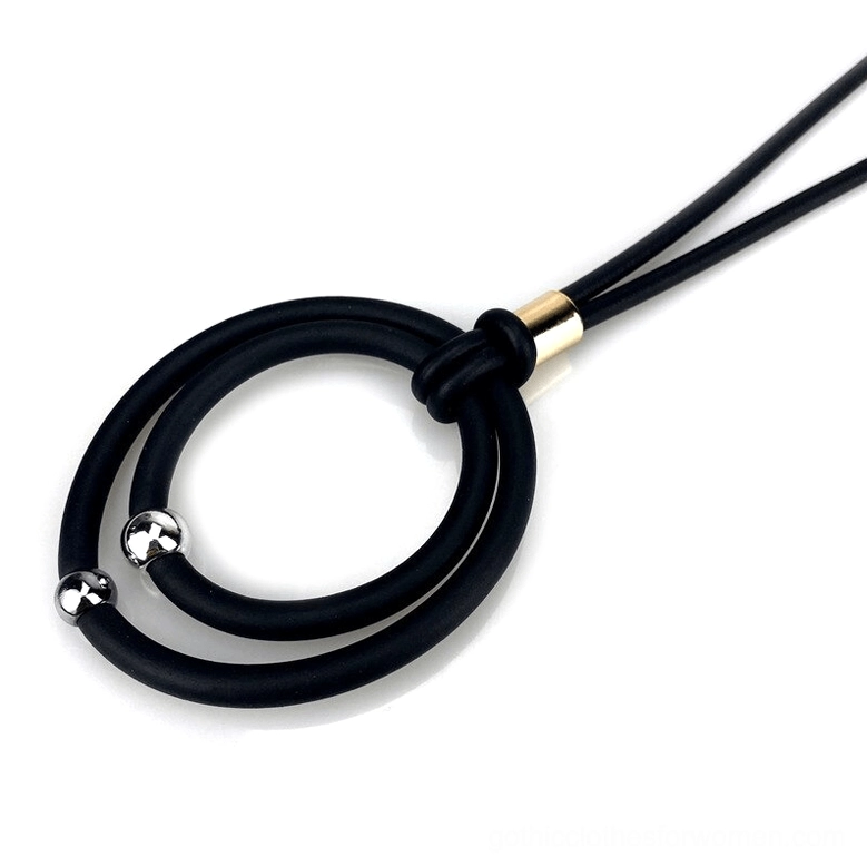 Detailed view of black gothic pendant necklace showing gold metal connector and dual circular pendant structure