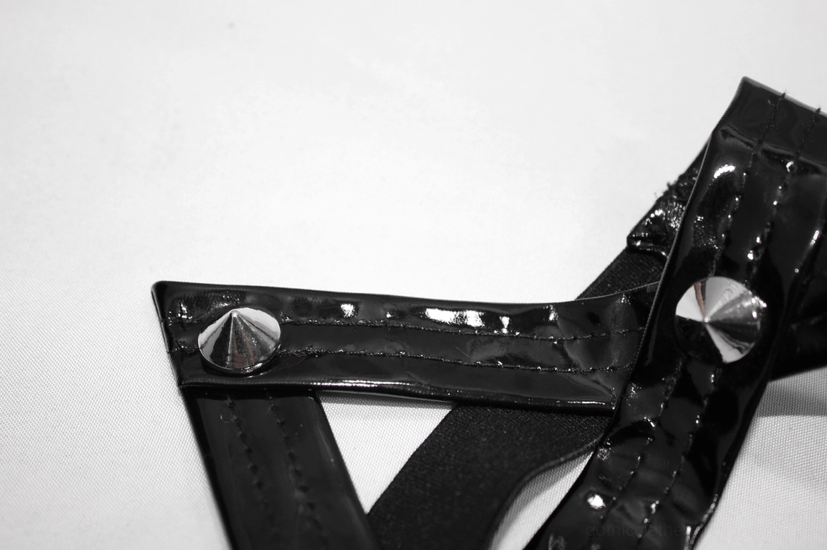 Ankle and leg opening view of black gothic pentagram pants showing slim fit silhouette