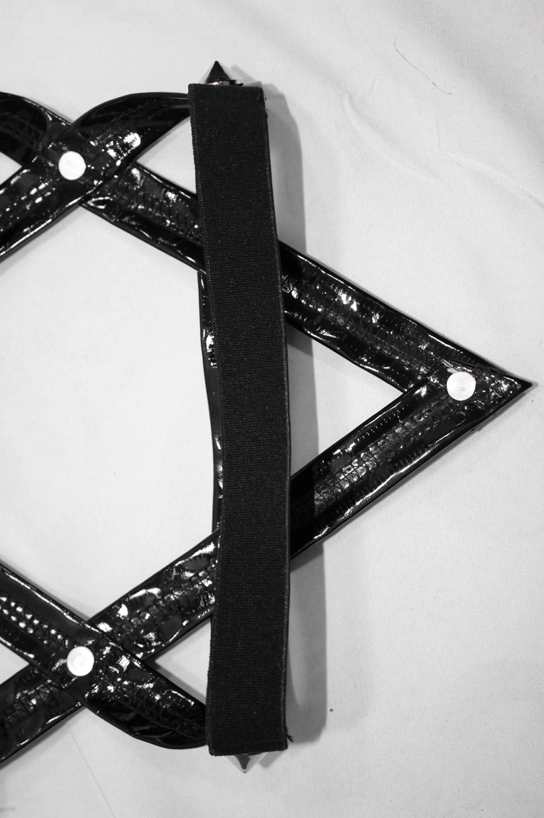 Full front view of black gothic pentagram pants on model displaying pentagram leg strap system