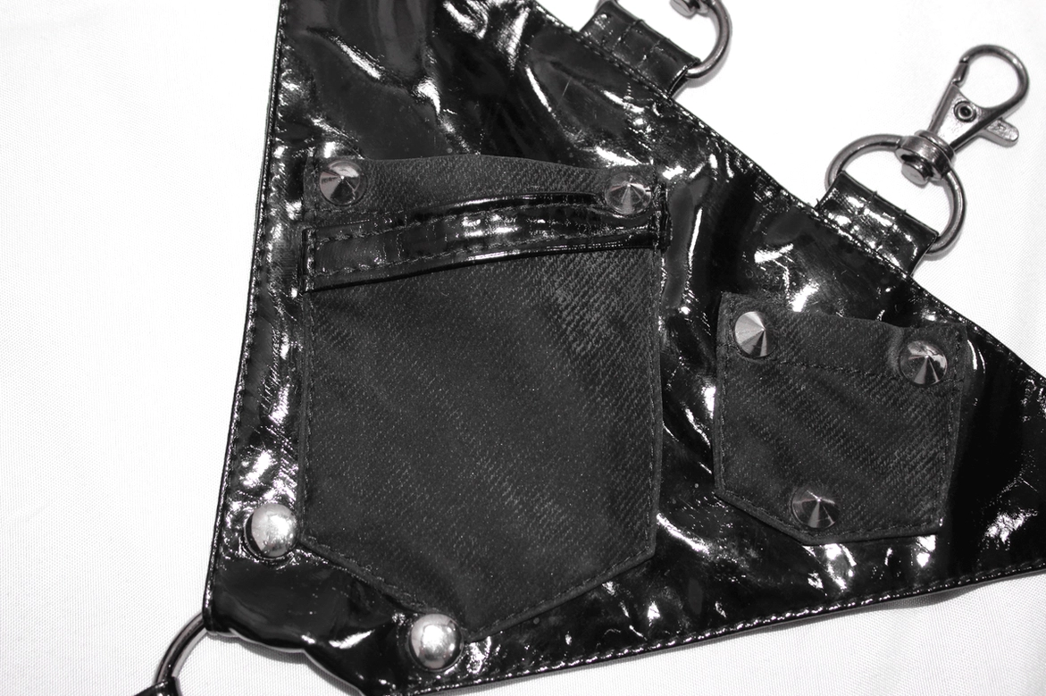 Side profile of black gothic pentagram pants displaying layered straps and pentagram buckles