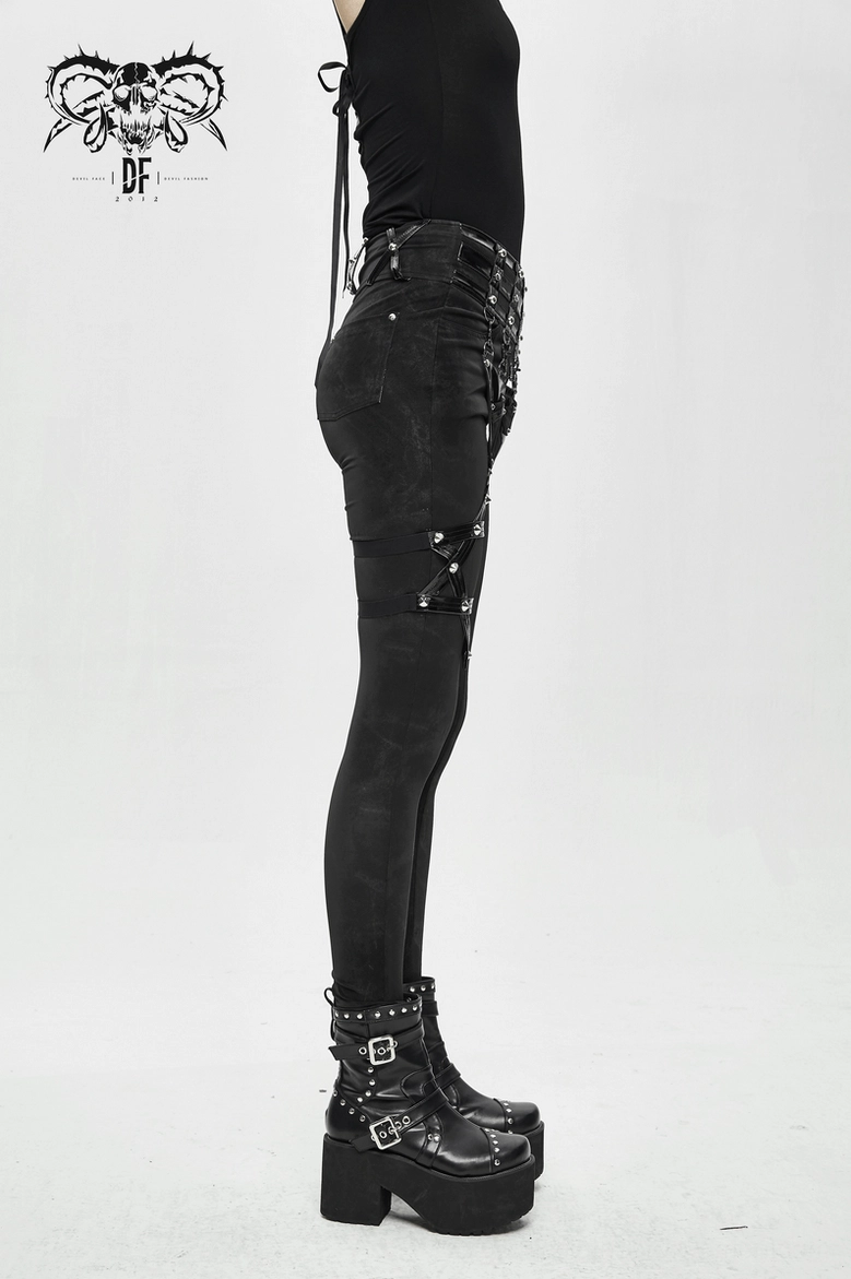 Waist and hip detail of black gothic pentagram pants showing metal stud placement and fit
