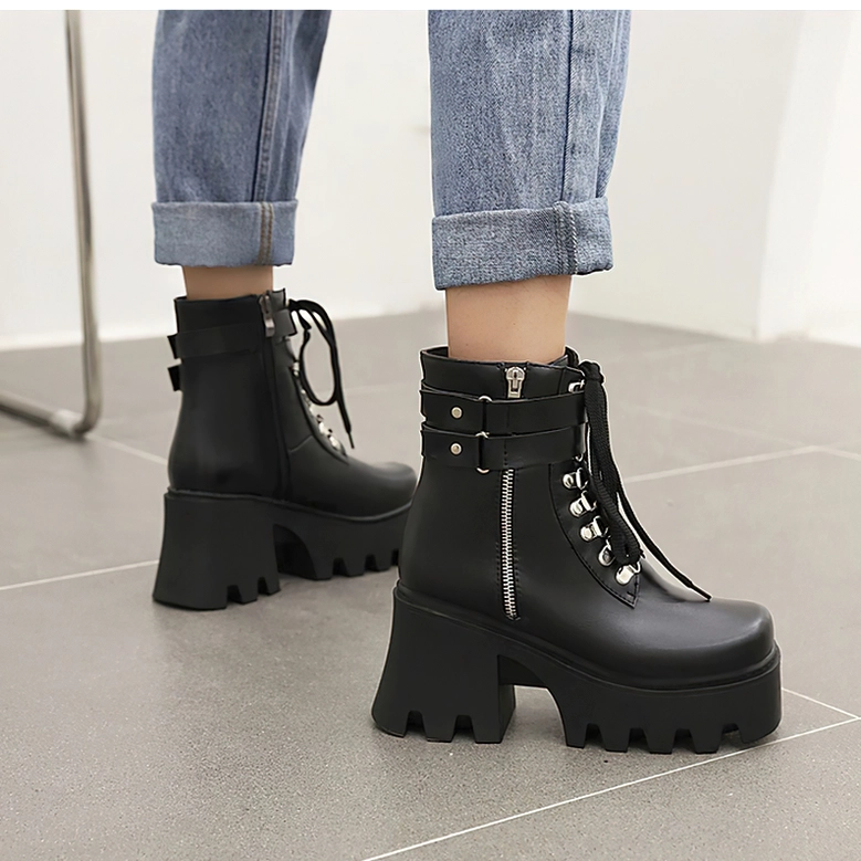 Black gothic platform boots worn with jeans, side angle showcasing the substantial square heel and industrial platform silhouette