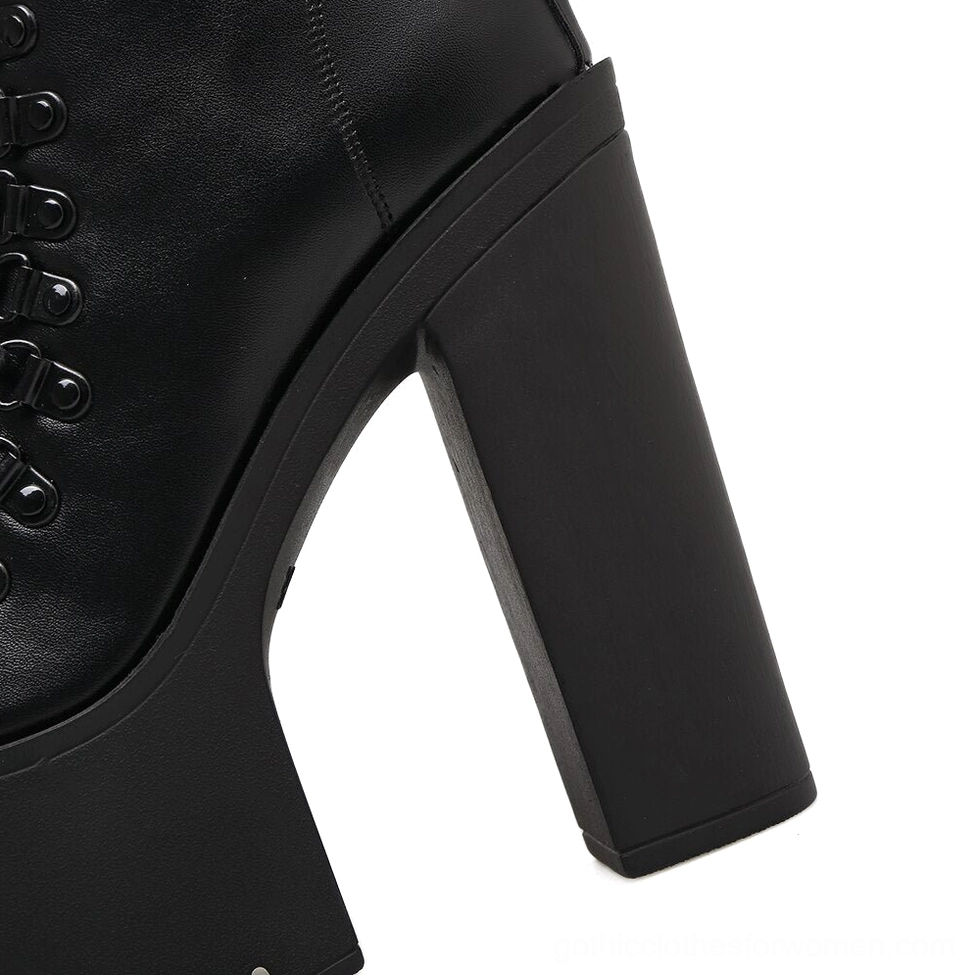 Black platform boot heel and upper close-up detail showing metal lace eyelets and smooth leather construction