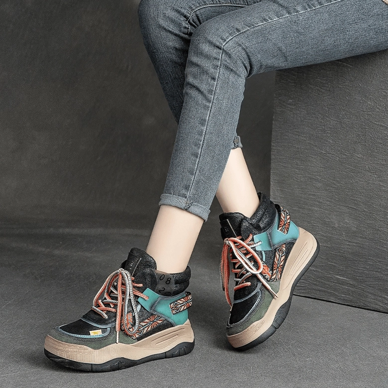 Woman in black gothic platform lace-up boots with rolled-up skinny jeans, low-angle side view in studio setting
