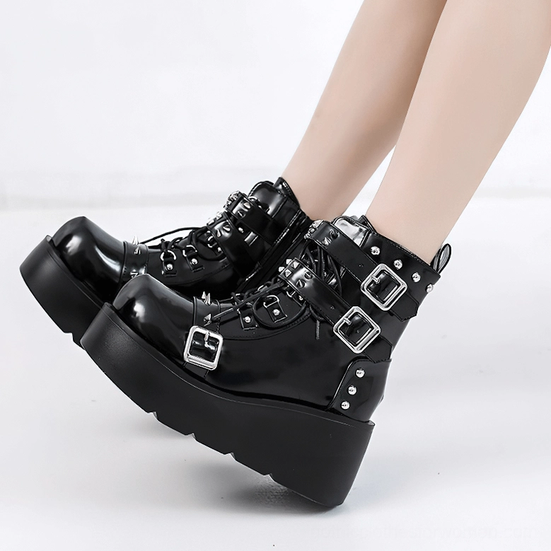 Black gothic platform ankle boots worn by model rear view showing buckles and platform height