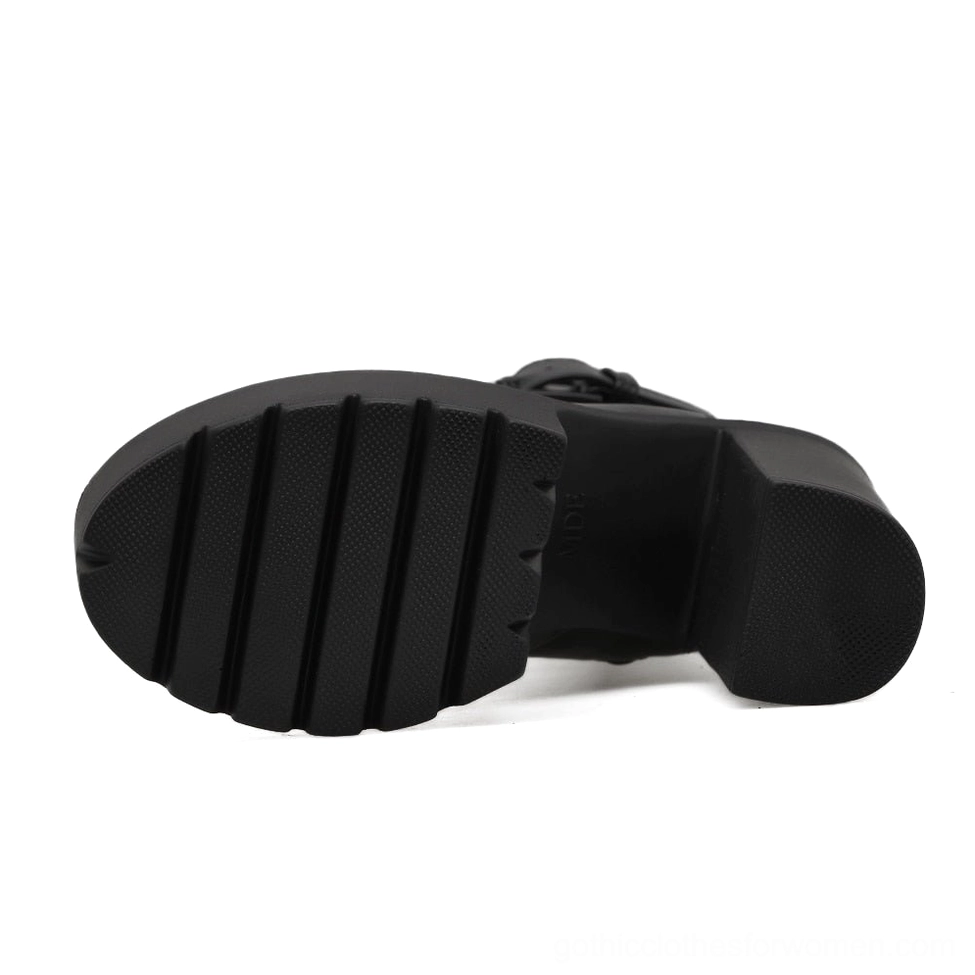 Black platform boot outsole and sole bottom showing anti-slip lug tread pattern and thick rubber base
