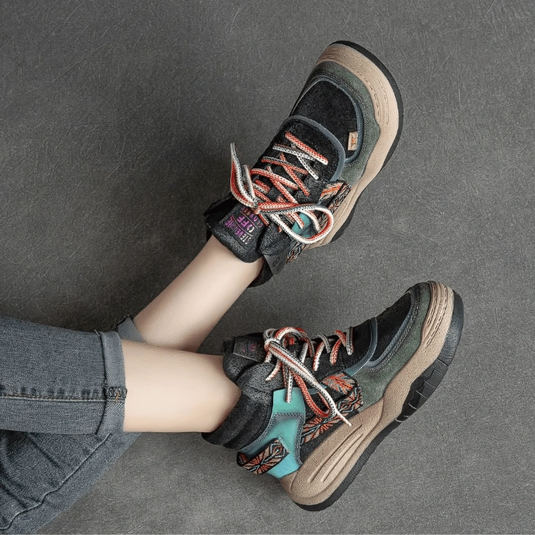 Black gothic platform boots on model wearing denim jeans, overhead close-up showing platform sole and turquoise boot details