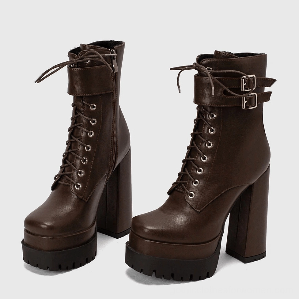 Pair of gothic platform ankle boots in black displaying full buckle strap and heel design