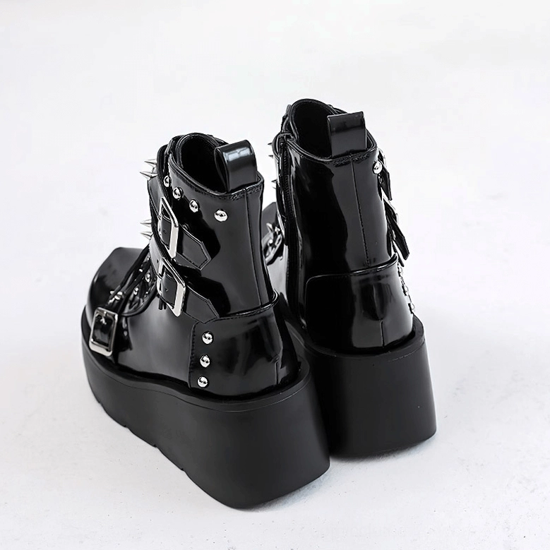Black gothic platform ankle boots rear three-quarter view showing buckle and rivet details