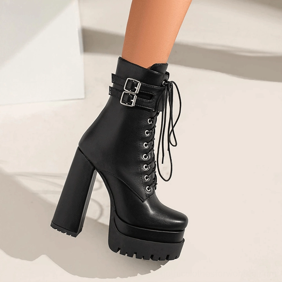 Detailed view of black gothic platform ankle boots showing side zipper and industrial buckle hardware