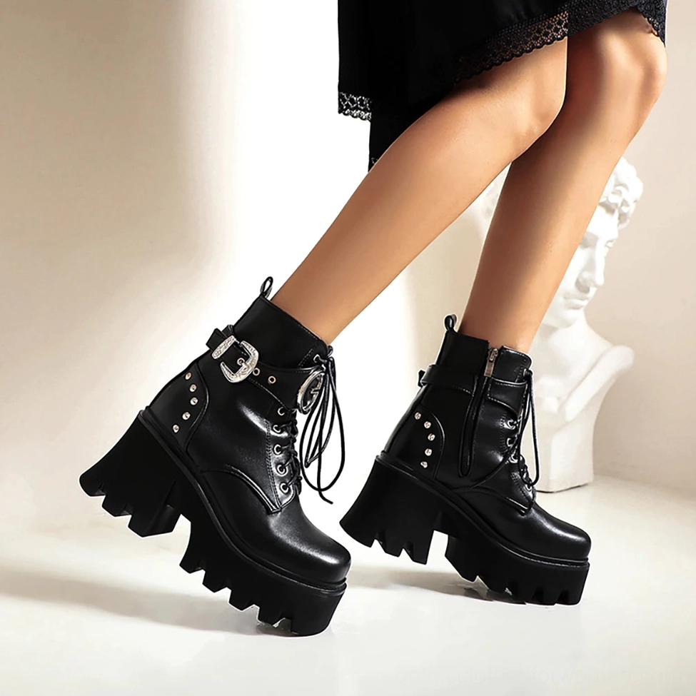 Woman wearing black gothic platform combat boots with chunky platform heel, indoor studio with art decor showing on-body styling