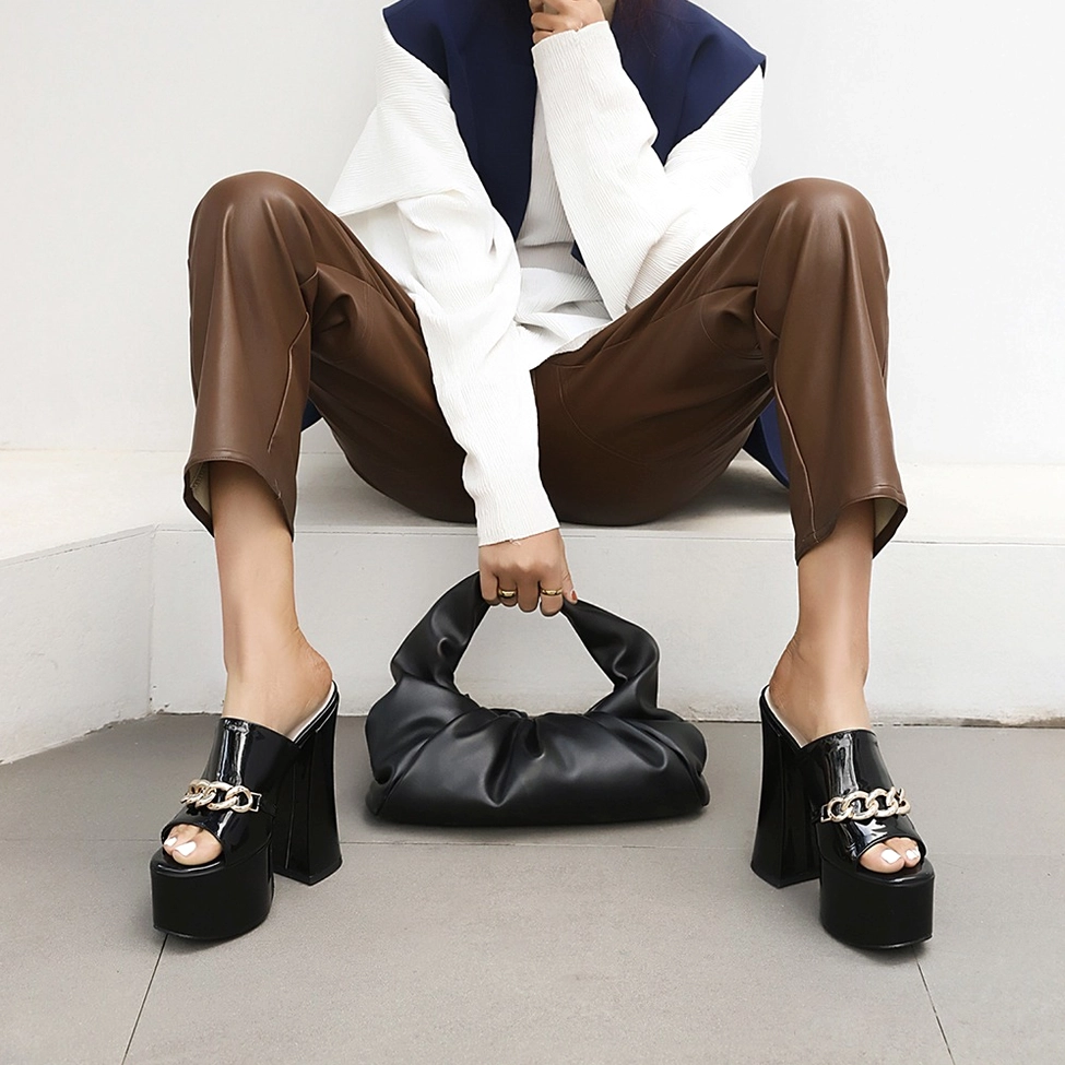 Black patent leather gothic platform heel showcasing full side profile and architectural square heel design