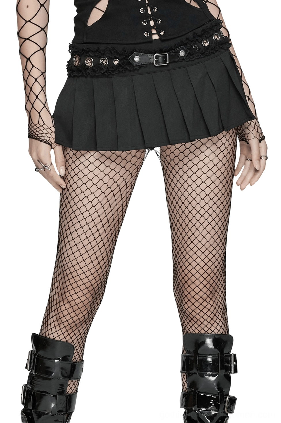 Black gothic pleated mini skirt with lace waistband and metal eyelets worn with fishnet stockings and buckled boots, front three-quarter view