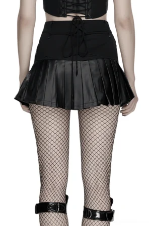 Black cyberpunk gothic skirt back view on model with lace-up back detail, cross strap, and pleated faux leather section, studio background