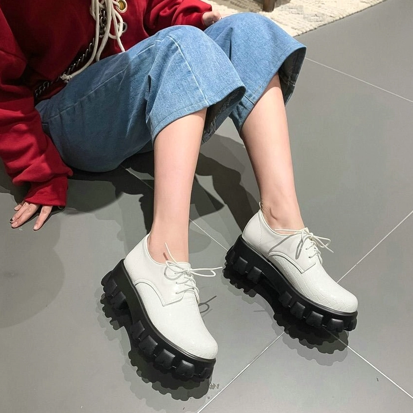 Black snake-pattern platform pump showcasing durability and edge-stitched construction of PU leather upper