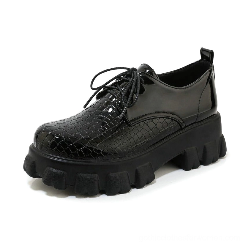 Black snake-pattern lace-up pump close-up detail view showing lacing system and square heel construction