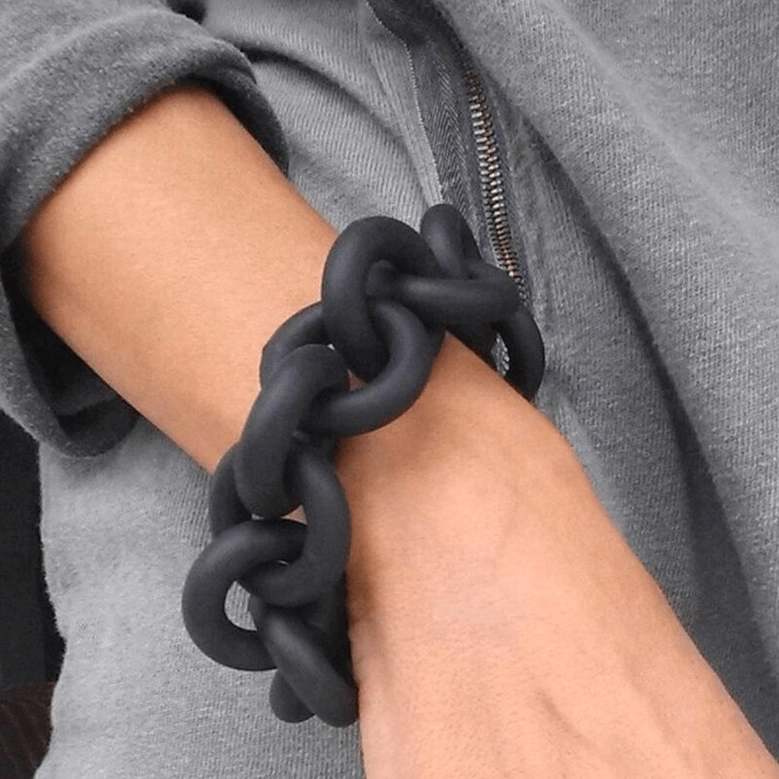 Gothic black rubber chain bangle bracelet fitted on female forearm, demonstrating perfect wrist wear and chain detail