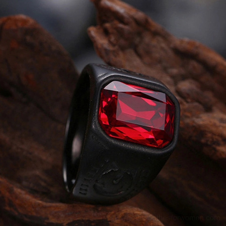 Black stainless steel gothic ring with red glass stone detail shot product photography