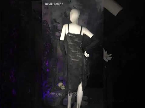 Black gothic ripped midi dress with long gloves on mannequin, partial back view with torn lace and dark themed background