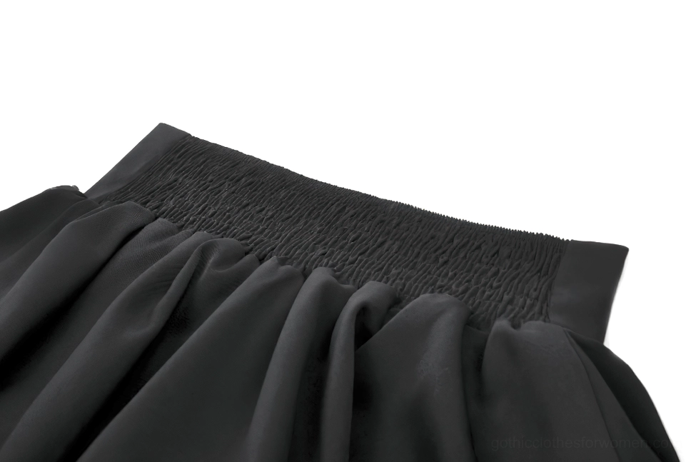 Black gothic ruffle mini skirt close-up of smocked elastic waistband showing stretch construction detail