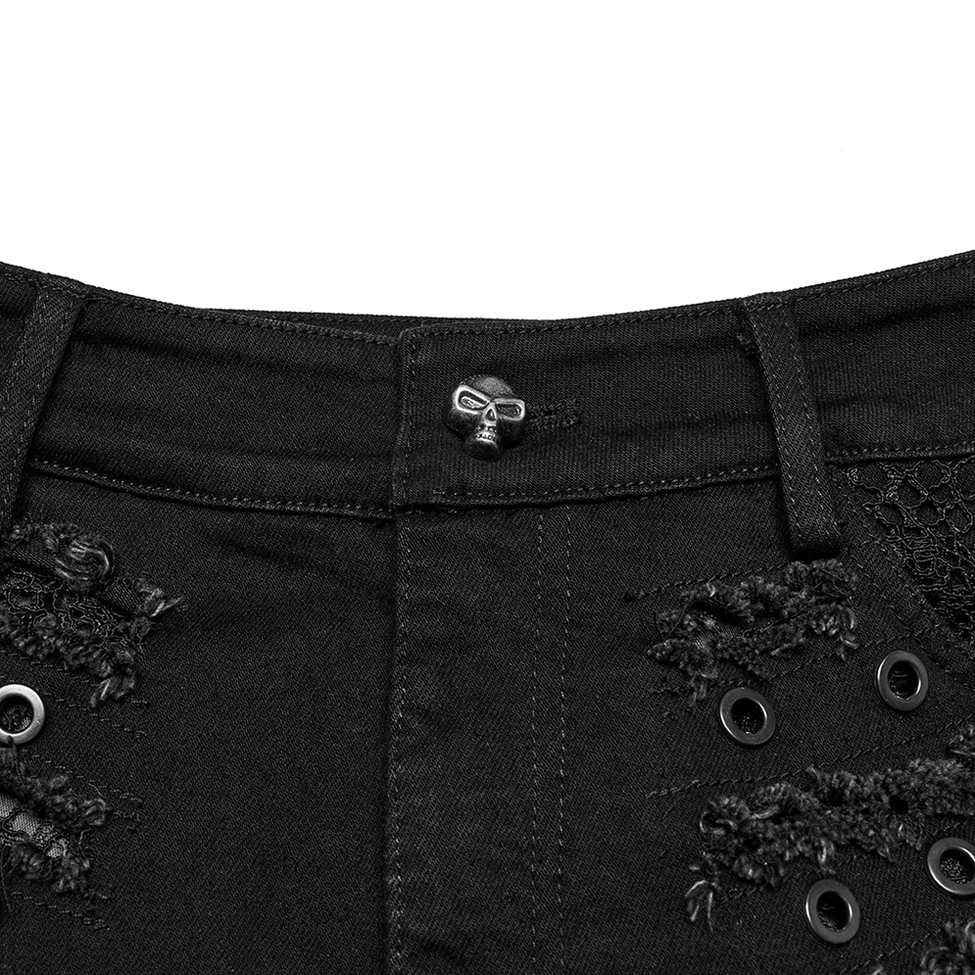 Close-up macro photography of gothic shorts waistband showing skull-shaped metal button and denim fabric texture with belt loops
