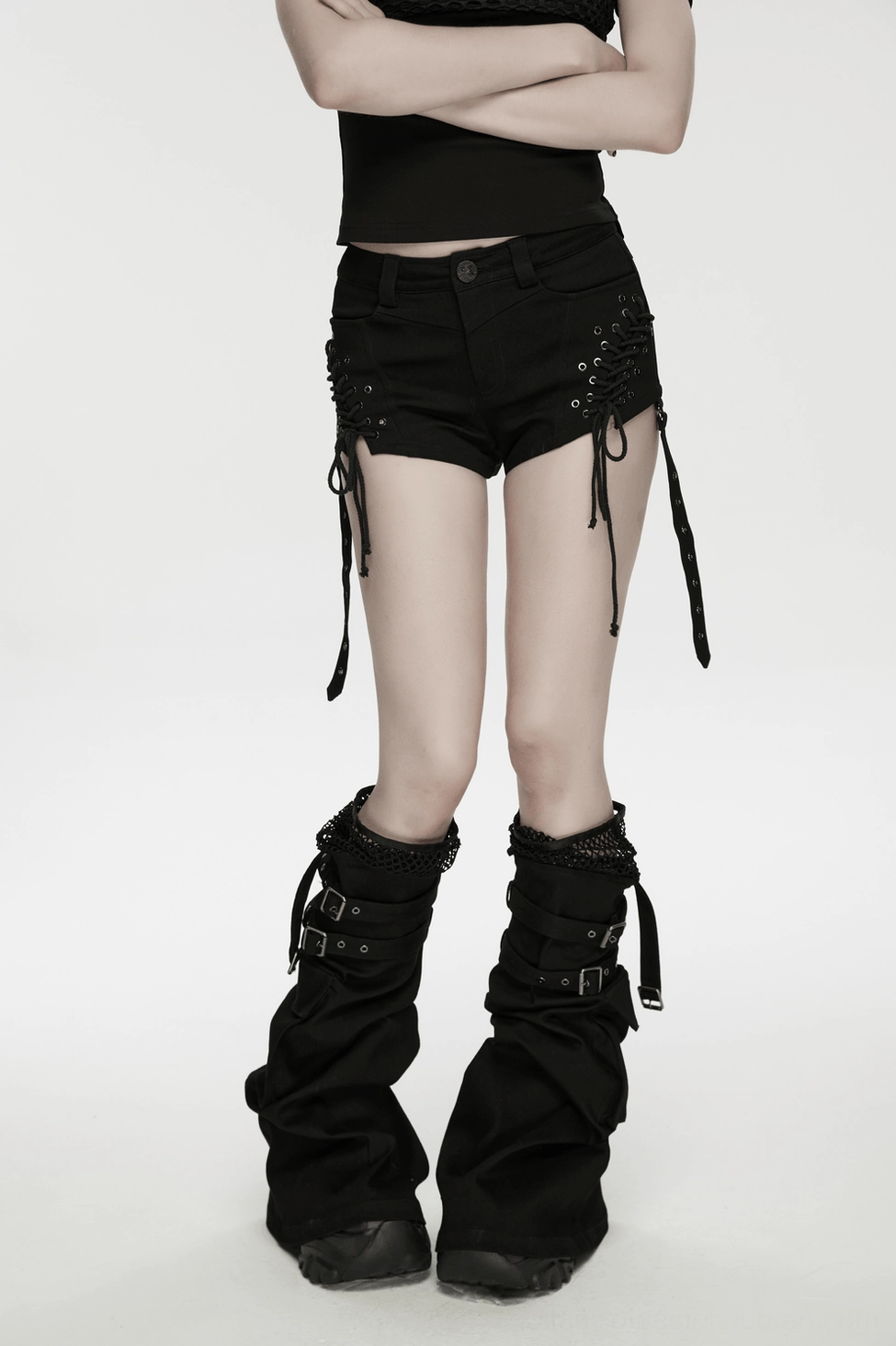 Black gothic shorts with lace-up sides and buckle details displayed on flat lay showing rebellious punk aesthetic