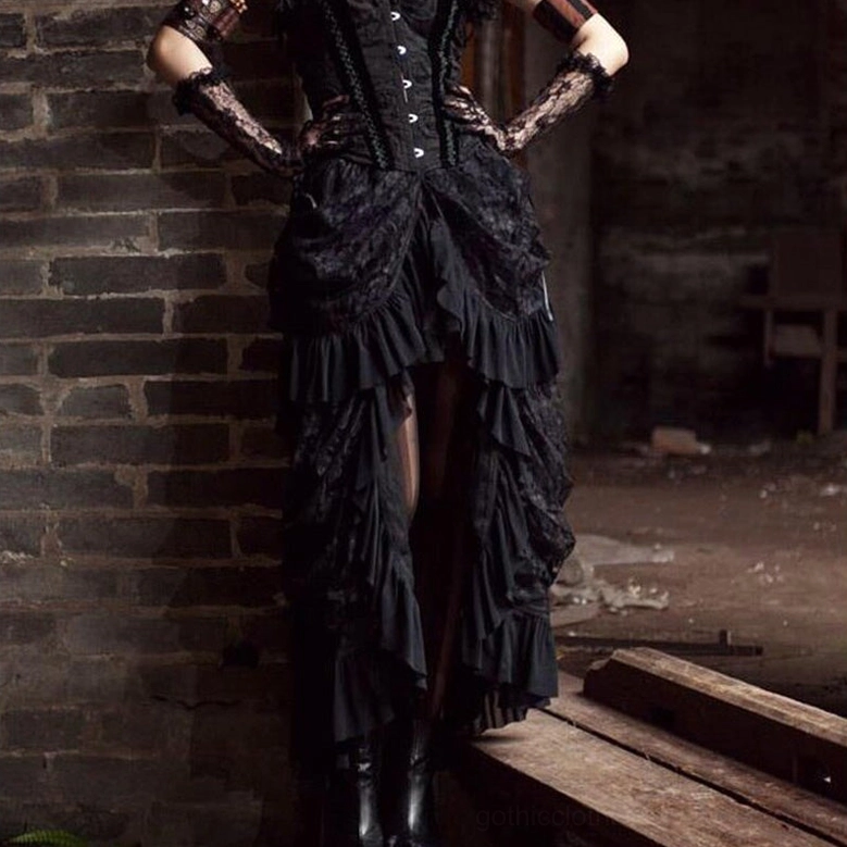 Black gothic corset skirt outfit on model indoor brick setting alternative fashion