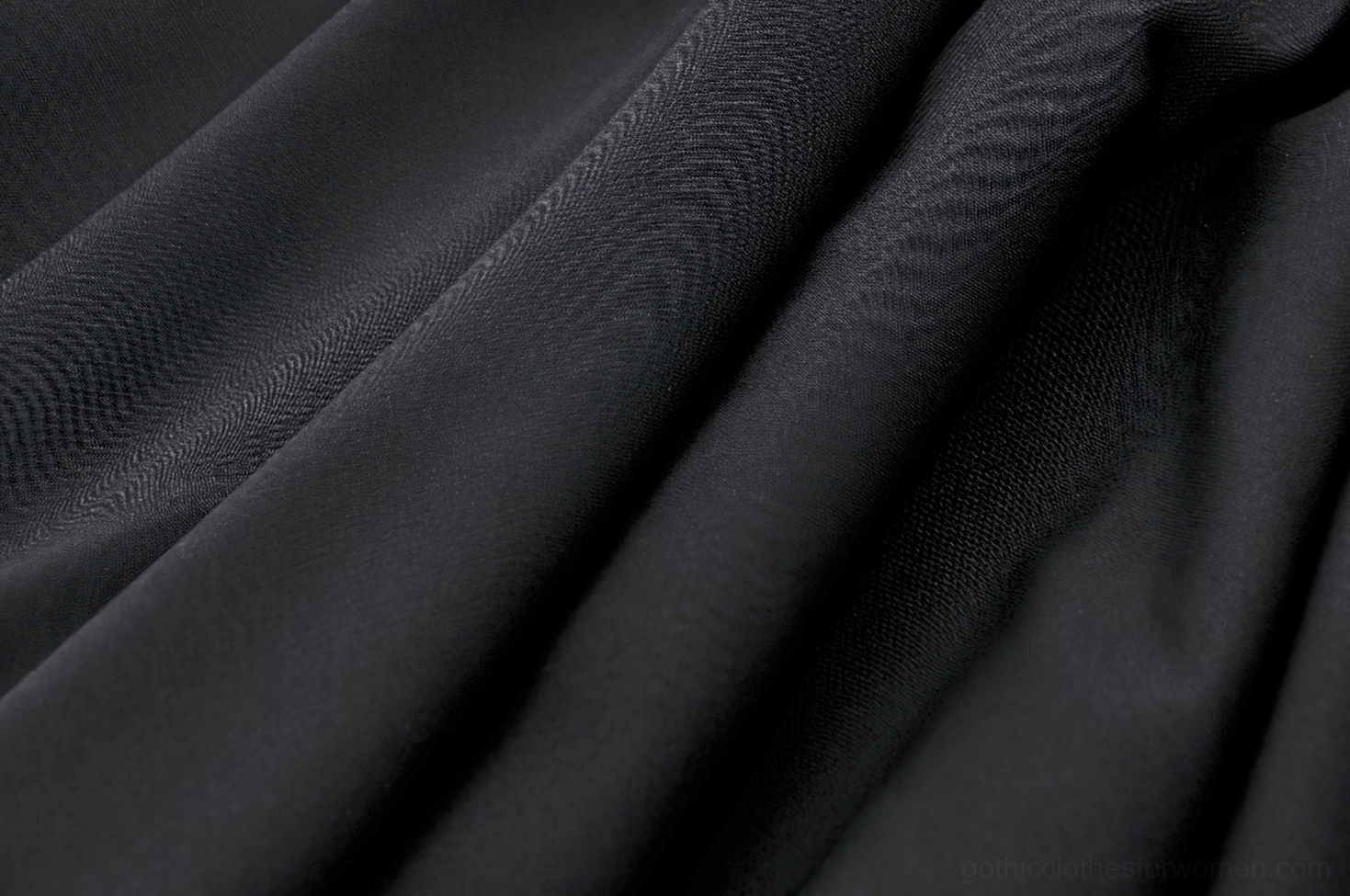 Black gothic skirt fabric texture close-up showing matte polyester weave