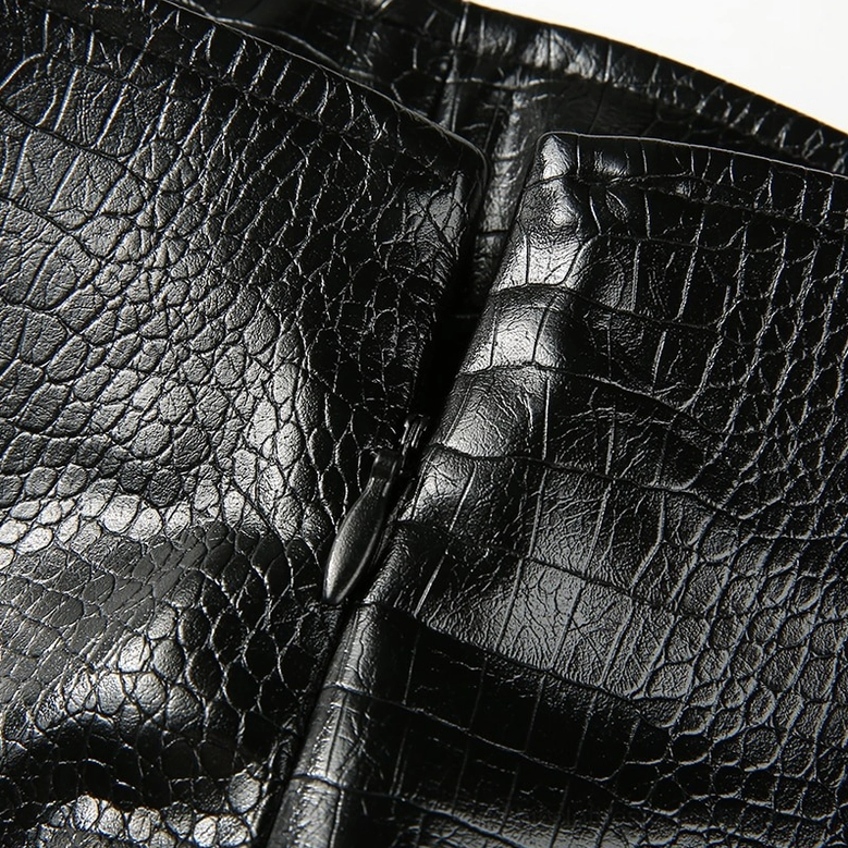 Metal zipper and crocodile PU leather seam construction on black gothic high-waist mini skirt