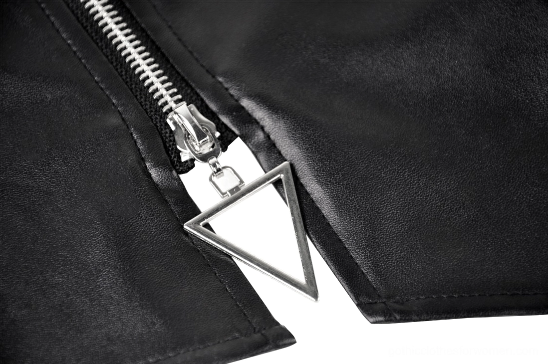 Macro close-up of triangle metal zipper puller on black asymmetric faux leather gothic skirt