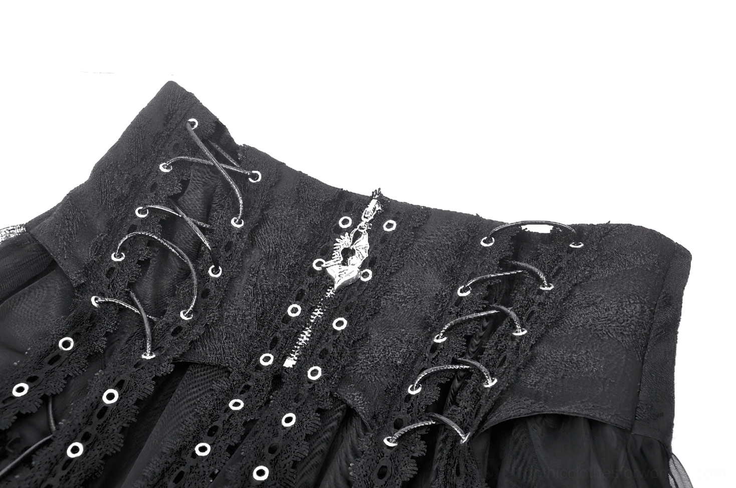 Close-up detail of black gothic skirt waistband showing eyelet corset lacing, metal cross zipper pendant, and jacquard fabric texture